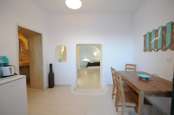 Cave Apartment, decorated in white hues, accommodates up to 4 adult guests.<br / Fira, Greece Manias Fira Residences  | Cave Apartment [36 m²] Entire rental unit vacation rental 7867436