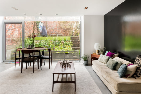 Open folding wooden doors to let morning light stream into a minimalist bedroom. Fosbury, United Kingdom Shop for Furniture and Fashion from an Elegant Garden Flat Entire condo vacation rental 25042247