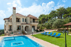 The porticoed main entrance door leads into a spacious L shaped, open plan livin Chania, Greece Traditional stone made mansion, pool, elevator Entire home vacation rental 17540337
