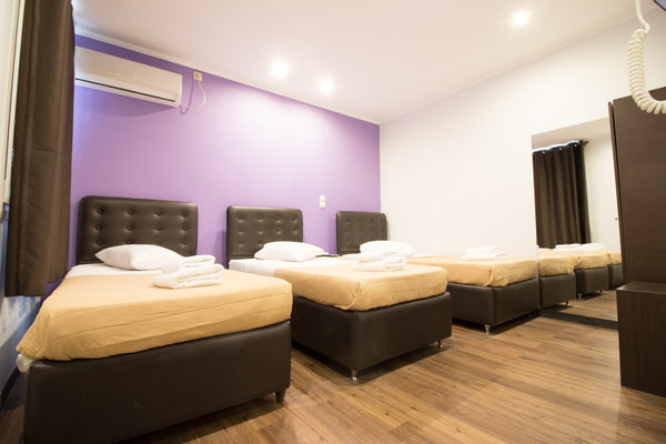 Room is fitted with dark leather furniture and wooden flooring. There is possibi US Triple Room Ensuite | Cosmopolit Hotel Room in hotel vacation rental 53485735