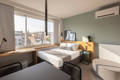 The studio features a queen size bed, a kitchen with a dining space, an A/C unit Thessaloniki, Greece #FLH - K4.03 City Apartment, Thessaloniki Entire rental unit vacation rental 707714401173392294