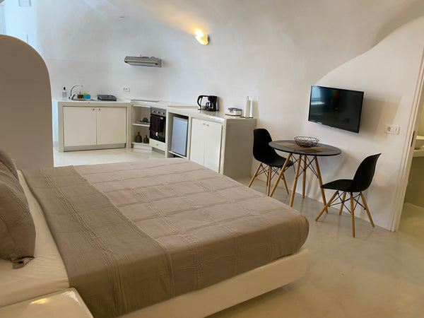 Cally Cave Jacuzzi Suite B features open space with queen size bed and bathroom, Thera, Greece Cally Cave Jacuzzi Suite double, near Fira Room in hotel vacation rental 44924318