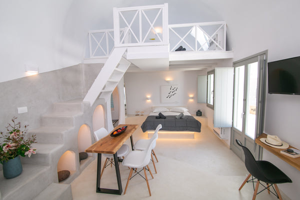 The apartment stretches in two different levels. Upstairs, a cozy loft bedroom w Greece Théros | Shades of White Cycladic home vacation rental 25044377