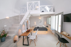 The apartment stretches in two different levels. Upstairs, a cozy loft bedroom w Greece Théros | Shades of White Cycladic home vacation rental 25044377
