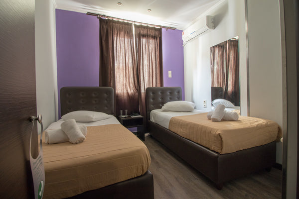 Room is fitted with 2 dark leather single beds and wooden flooring. A crib can b US Twin Room | Cosmopolit Hotel Room in hotel vacation rental 53485715