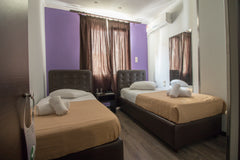 Room is fitted with 2 dark leather single beds and wooden flooring. A crib can b US Twin Room | Cosmopolit Hotel Room in hotel vacation rental 53485715