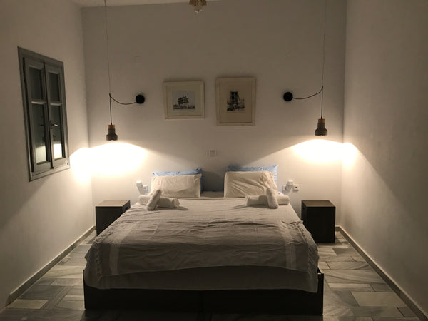 A two room house and a kitchen.The bedroom has a twin sized bed the living room  Athens, Greece blanc Tinos ( kionia 2f) Cycladic home vacation rental 18352061