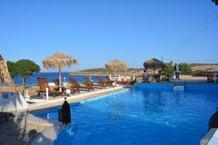 A painting with unforgettable sunrises,white sand and blue sea.....  <br />hidde Schoinousa, Greece Anatoli studios-Blue Sun Room in hotel vacation rental 40279071