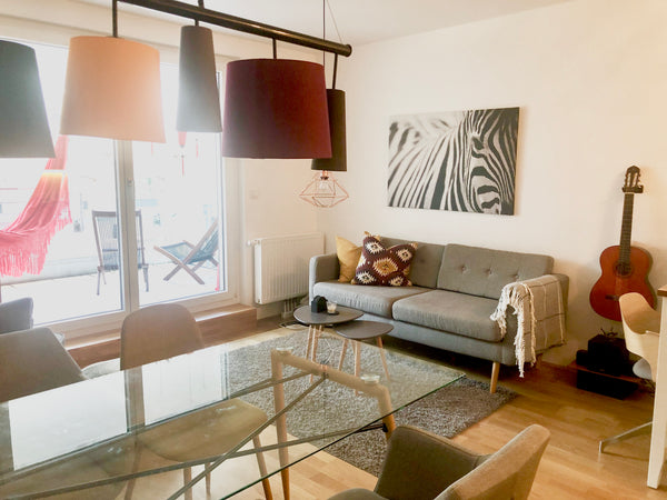 The apartment has an open plan living room kitchen with a counter, couch and arm Vienna, Austria Stylish apartment between Karlsplatz & Schönbrunn Entire rental unit vacation rental 35982782