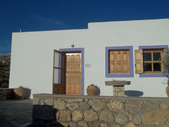 A large room with kitchen, dining table and soufa with double bed. A bedroom wit  Kefalaki family house . Entire home vacation rental 6926865