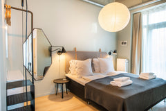 This bright and beautiful studio apartment is bathed in daylight from floor-to-c Copenhagen, Denmark By The Beach Apartments D - IntoThisPlace Room in serviced apartment vacation rental 26117463