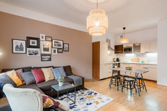 Snuggle up on the cozy L-shaped sofa surrounded by cushions and images of Prague Prague, Czechia Have a Romantic Getaway in a Stylish Apartment in Prague Entire rental unit vacation rental 25901425