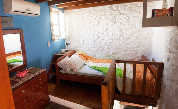 Stone house that contains a living room with a transforming bunk bed, a bathroom  Traditional guest house in the heart of Ano Syros. Entire home vacation rental 13392852