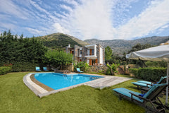 This property is a 15-minute walk from the beach. Showcasing a barbecue and sun  Heraklion, Greece Manolioudis Villas, Private Villa, Private Pool Entire villa vacation rental 21985827