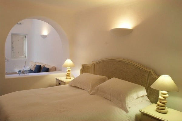 This open plan suite with its spacious living room area includes a built in sofa  Junior Suite with shared pool & caldera view Private room in bed and breakfast vacation rental 21709474