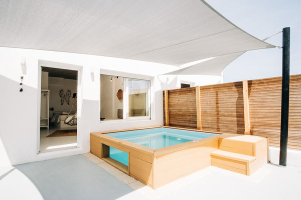 The open plan design features a bedroom with a queen size bed, a lounge area / s  Mesanto Deluxe Suite | Outdoor Hot Tub Entire rental unit vacation rental 39595902